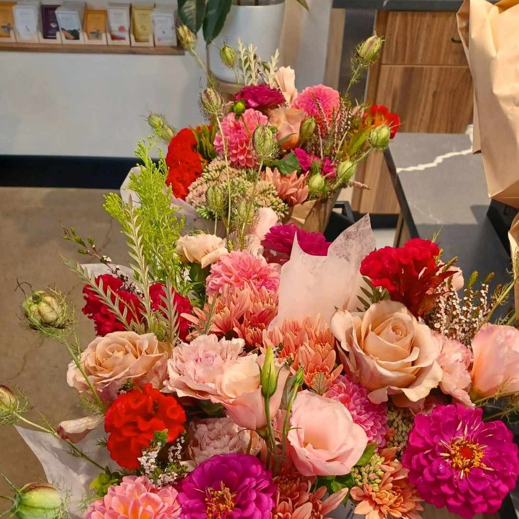 Bouquet of colorful flowers on a table with a blurred indoor background